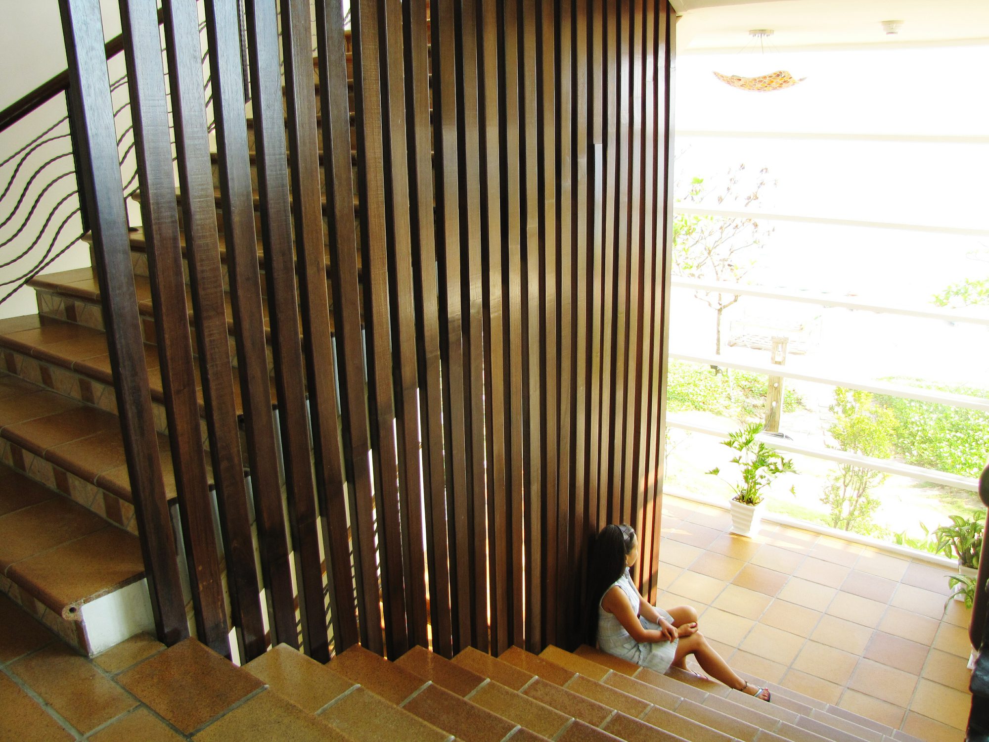 high angle view woman sitting staircase home